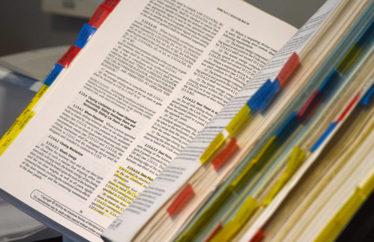 Opened book with many bookmarks on the side